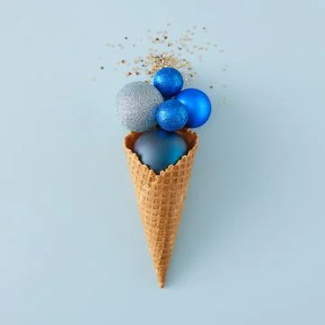 Christmas tree balls and sequins in ice cream cone Stock Photos