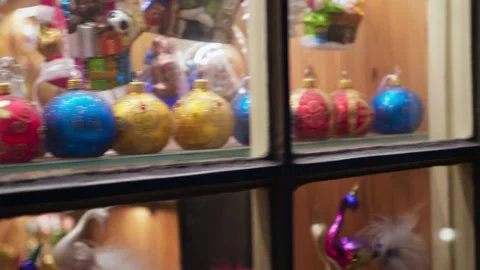 Christmas tree balls on display in a store window, Catholic Christmas Eve. Stock Footage 264661706
