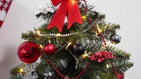 Christmas tree with beads, balls, shape of snowflake, bows and garland, 4k. Stock Footage 219547311
