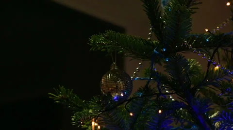 Christmas tree being decorated by a young girl with red hair Видео 33374768
