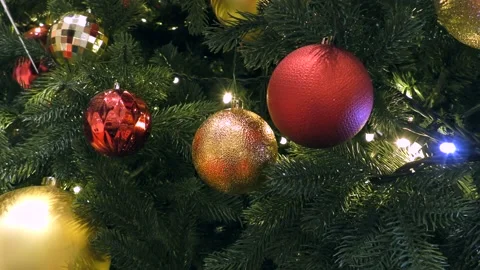 Christmas tree with blinking lights, colorful balls, and festive decorations. Video stock 166703024