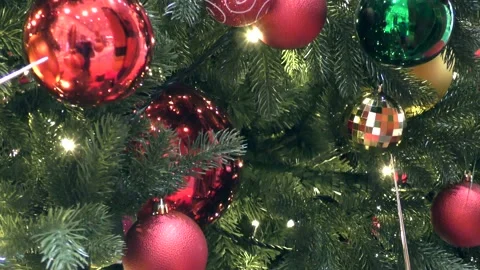 Christmas tree with blinking lights, colorful balls, and festive decorations. Stock Footage