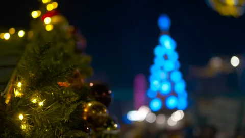 Christmas tree with blue lights blurred in the background at night Stock Footage 310320272