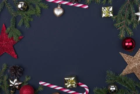 Christmas tree branchers, balls, candy on black background, preparing for the Stock Photos