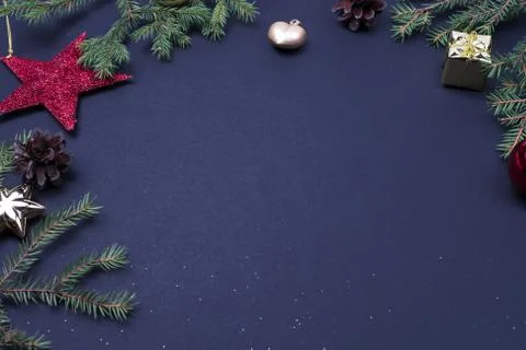 Christmas tree branchers, balls, candy on black background, preparing for the Stock Photos
