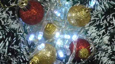 Christmas tree branches with balls and a glowing garland Stock Footage 142560199