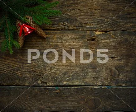 Christmas tree branches with cones and christmas decorations on wooden textur Stock Photos