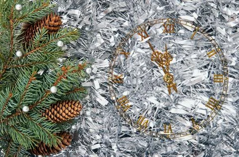 Christmas tree branches with cones in silver tinsel. Christmas background. Stock-Fotos