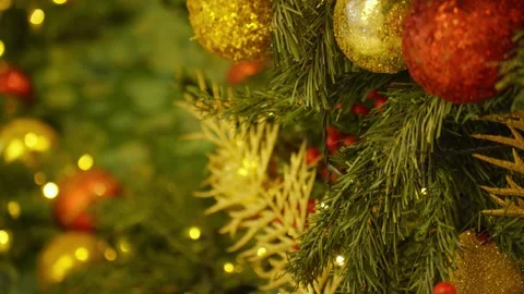 Christmas tree branches decorated with golden and red baubles  스톡 동영상 344347032