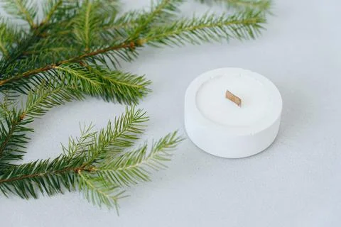 Christmas Tree Branches side View Next to Round Flat White Candlestick. Copy  Stock Photos
