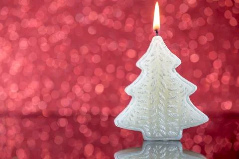 Christmas tree candle light with reflection on red blurred bokeh 스톡 사진