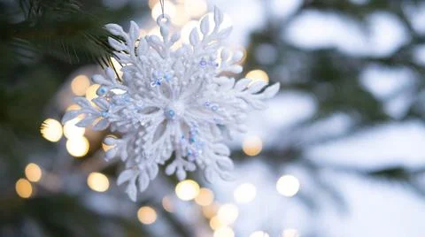 Christmas tree. Christmas tree with a snowflake Christmas toy, with a garland in Stock Photos