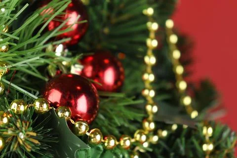 Christmas tree close-up, spruce branches with red balls Stock Photos