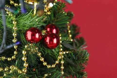 Christmas tree close-up, spruce branches with red balls Stock Photos
