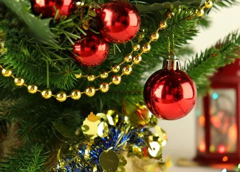 Christmas tree close-up, spruce branches with red balls Stock Photos
