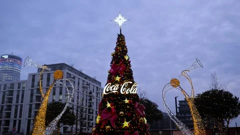 Christmas tree with Coca-Cola logo and festive lights in evening Stock Footage 318462165