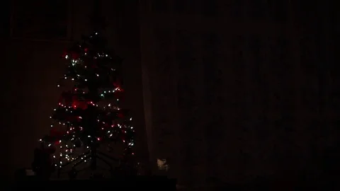 Christmas tree with colored lights set on a nightstand Stock Footage 83052580