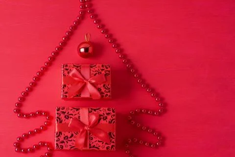 Christmas tree composition beads gift boxes ball red wooden background Stock Photos