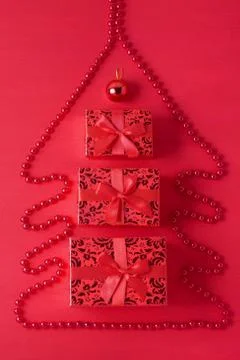 Christmas tree composition beads gift boxes ball red wooden background Stock Photos