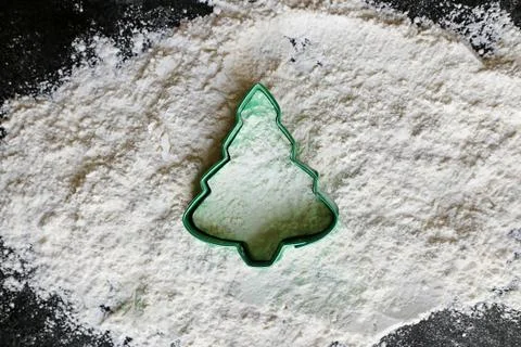 Christmas Tree Cookie Cutter in Baking Flour Stock Photos