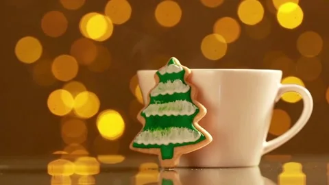 Christmas tree cookie leaning against white coffee cup background Video stock 333817269