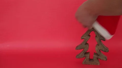 Christmas tree is covered with Santa's red hat, colourful gifts are placed and t Stock Footage 70559635