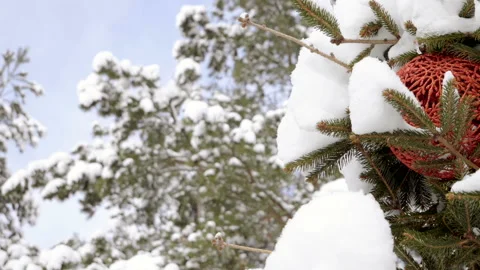 Christmas tree covered with snow, decorated with sparkly toys. Slow motion. HD Video stock 101152075