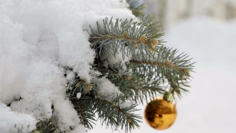 Christmas tree covered with snow, decorated with sparkly toys. Slow motion. HD Stock Footage 101152865