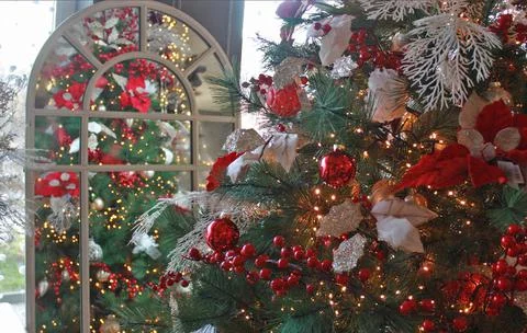 Christmas tree decorated with balls in the reflection of the mirror Stock Photos