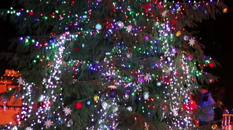 Christmas tree decorated with lights, toys at night Stock Footage 59589583