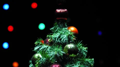 Christmas tree decorated with multi-colored balls on a dark background rotating  Stock Footage 252833036