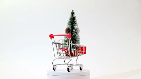Christmas tree decorated with New Year's toys rotates in a grocery shopping cart Stock Footage 144675631