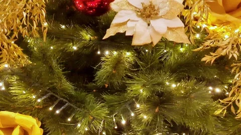 Christmas tree decorated with red and golden flowers, balls, lights in big house Video stock 289215941