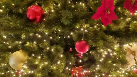 Christmas tree decorated with red and golden flowers, balls, lights in big house Video stock 289216080