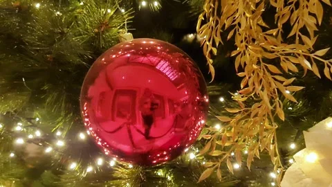 Christmas tree decorated with red and golden flowers, balls, lights in big house Video stock 289216140