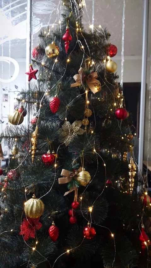 Christmas Tree Decorated with Red and Gold Baubles and Lights Stock Footage 326360109