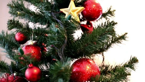 Christmas tree decorated with red baubles, white and red garland, jingle bells 스톡 동영상 96065553