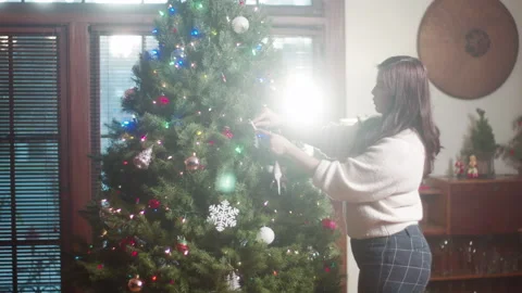 Christmas Tree Decorating 6K 48FPS SLO-MO Video stock 144463354