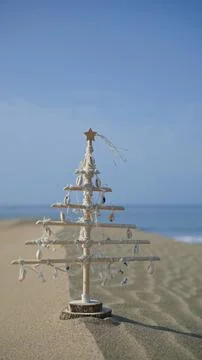 Christmas tree decorating sand dune on beach Stock Photos
