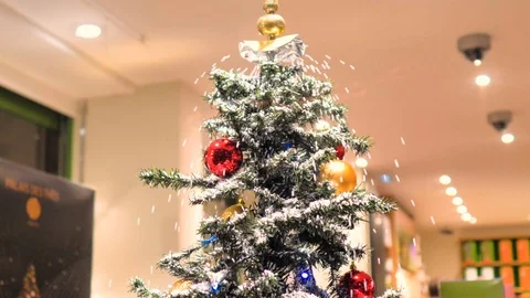 Christmas tree with decoration falls artificial snow Stock Footage 124480231