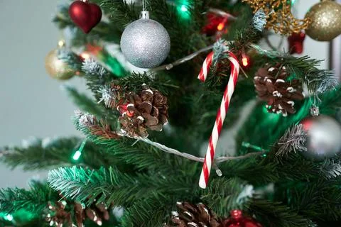 Christmas tree with decorations and candy canes, close-up. Stock Photos