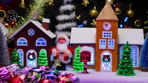 Christmas tree decorations and a small tree spinning against of a Christmas town Stock-Footage 292877150