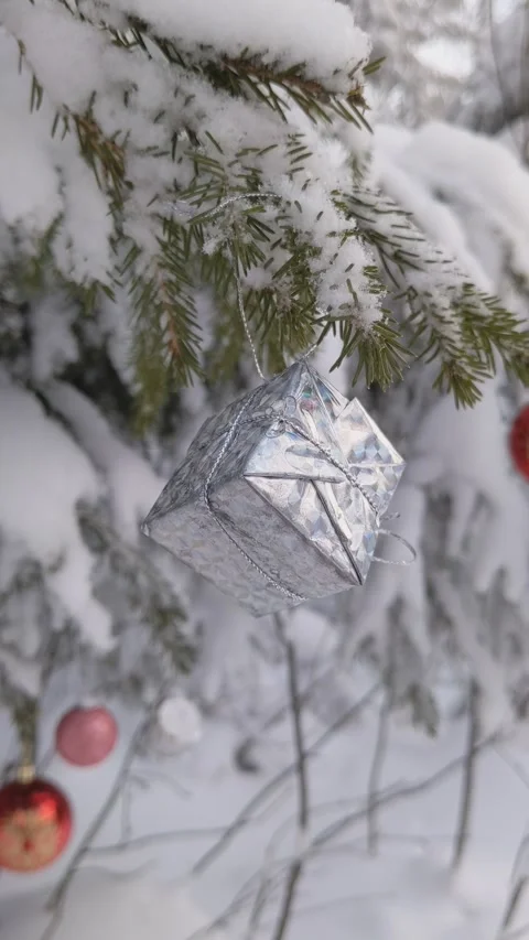 Christmas tree decorations in the forest. Gift box, drum, balls, snow Stock Footage 165777546