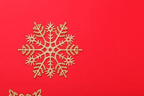 Christmas tree decorations in the form of golden stars on a red background Stock Photos