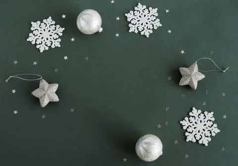 Christmas tree decorations frame top view with copy space on green background. M Stock Photos