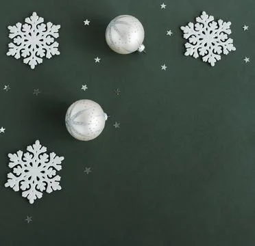 Christmas tree decorations frame top view with copy space on green background. M Stock Photos