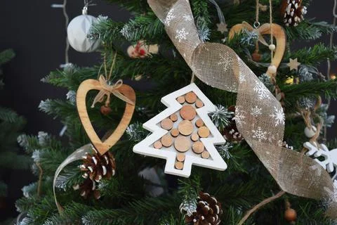 Christmas tree with decorations in a rustic style and garlands on a dark back Foto stock