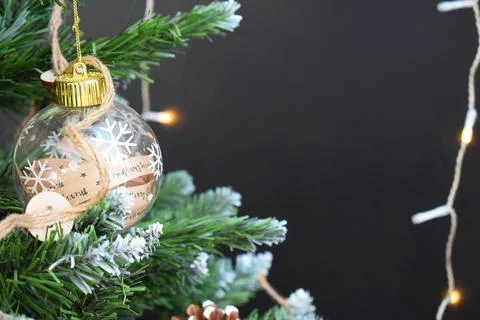 Christmas tree with decorations in a rustic style and garlands on a dark back Stock Photos