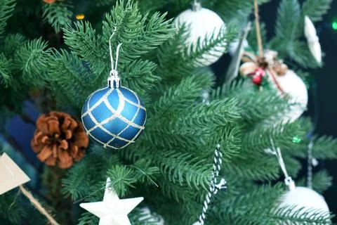 Christmas tree with decorations in a rustic style and garlands on a dark back Stock Photos