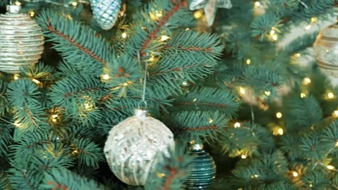 Christmas tree decorations in white and silver tones on a blue spruce Stock Footage 281004383